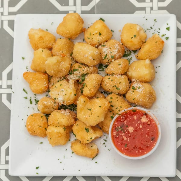 Island Social's fried cheese curds, sprinkled with parmesan and parsley, served with marinara sauce.